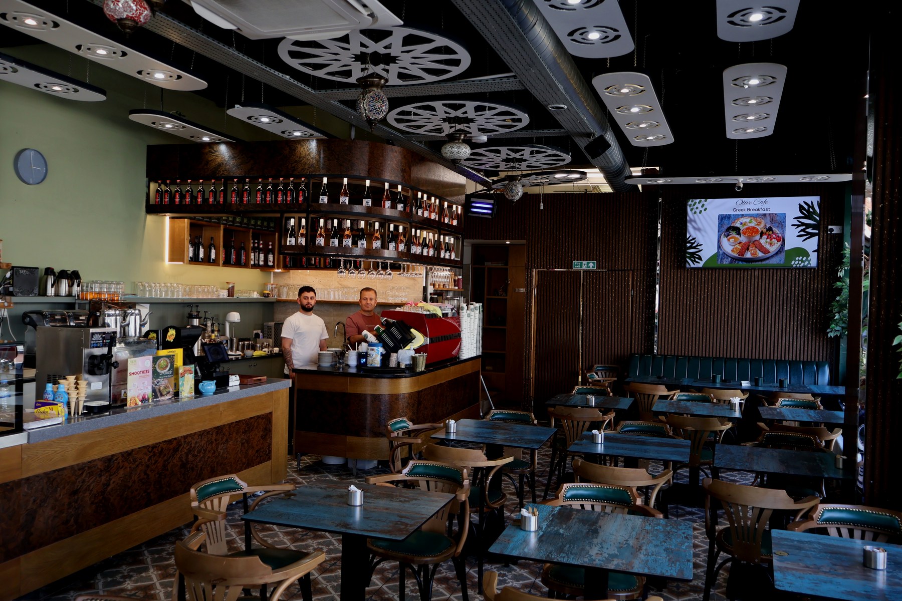 Inside The Olive Cafe & Bakery — counter, dining tables and Mediterranean interior in Palmers Green, Enfield N13