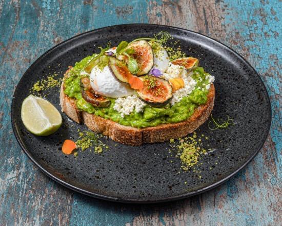 Avocado toast with poached egg, smoked salmon and fresh figs on sourdough
