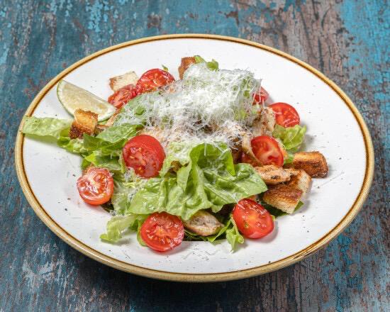 Chicken Caesar salad with grilled chicken, croutons, tomatoes and parmesan