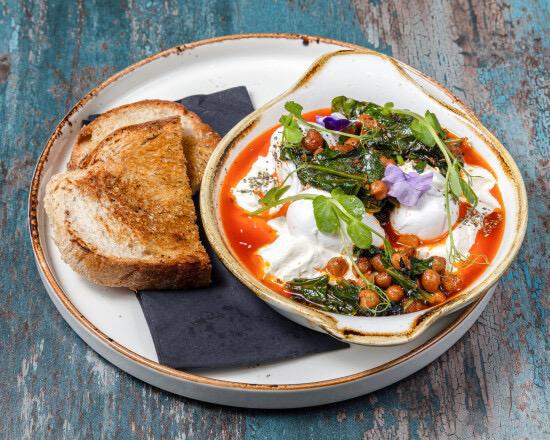Cilbir — Turkish poached eggs in garlic yoghurt with spinach and chickpeas