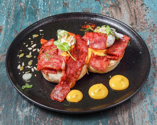 Eggs Benedict with sucuk and hollandaise sauce on toasted muffin