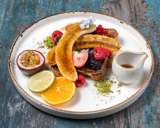French toast with caramelised banana, fresh berries and maple syrup