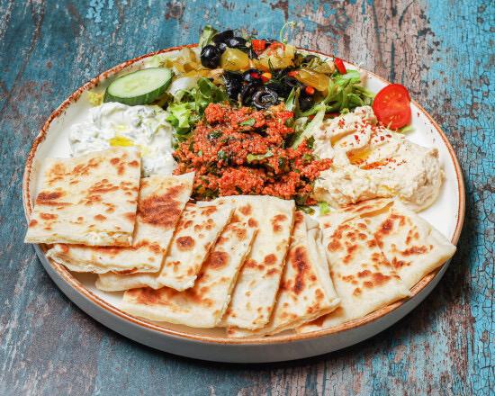 Gözleme mezze platter with hummus, tabbouleh, tzatziki and fresh flatbread