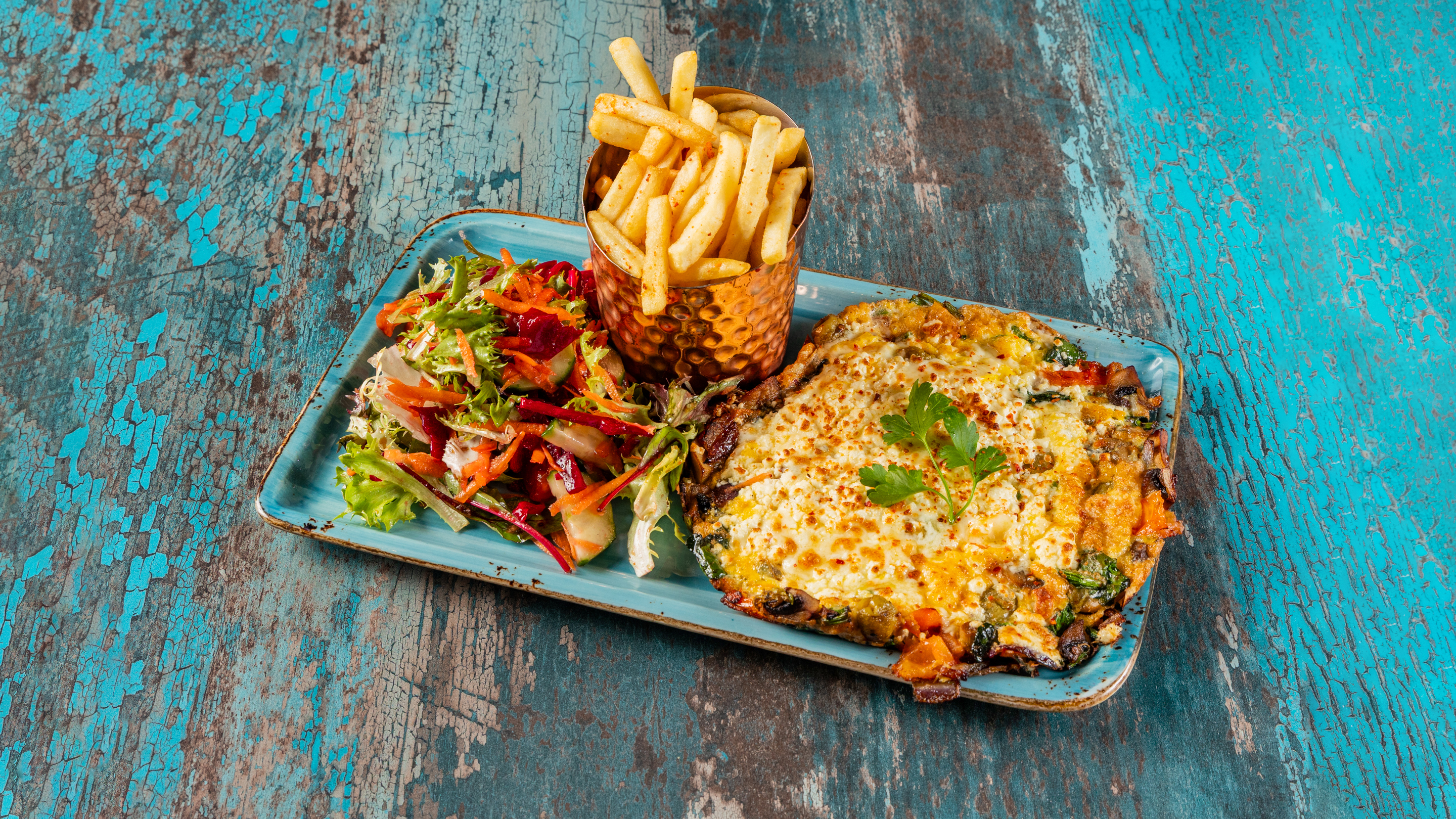 Spanish omelette with spinach and mozzarella served with chips and salad