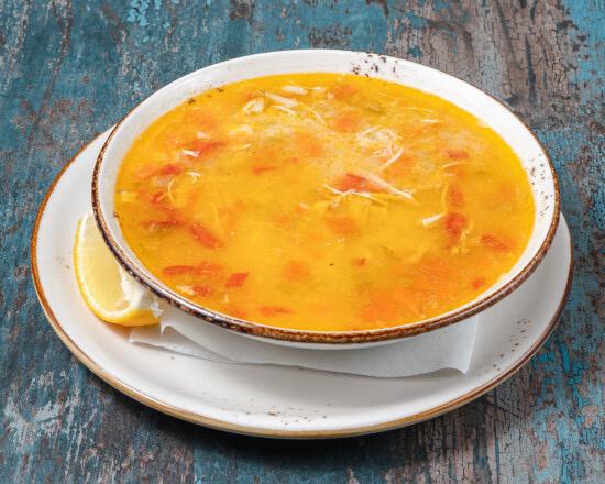Lentil soup served with lemon and fresh bread